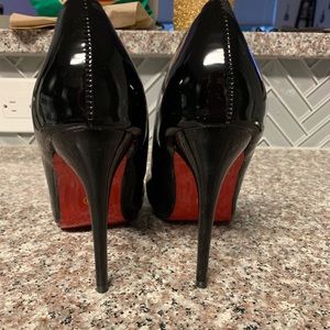 Black pointed toe heels with red bottom